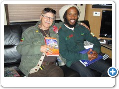 Dr. Bob Hieronimus and Ziggy Marley on the tour bus posing with some of the books given to him and his tour mates from 21st Century Radio and Drs. Bob and Zohara Hieronimus.
