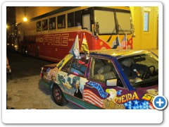 Ziggy Marley’s “Wild and Free” Tour Bus next to Dr. Bob Hieronimus’s “We The People” Artcar.